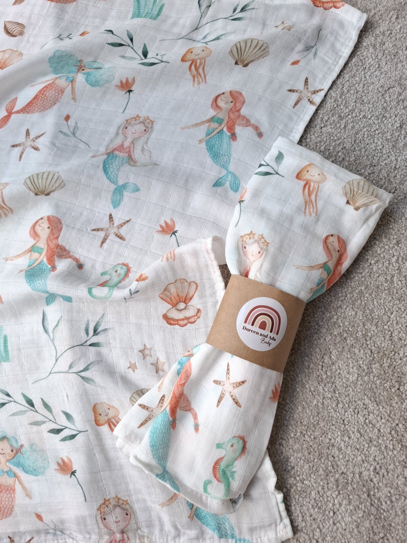 Muslin squares laid out to display mermaid and sea life designs on super soft cotton fabric