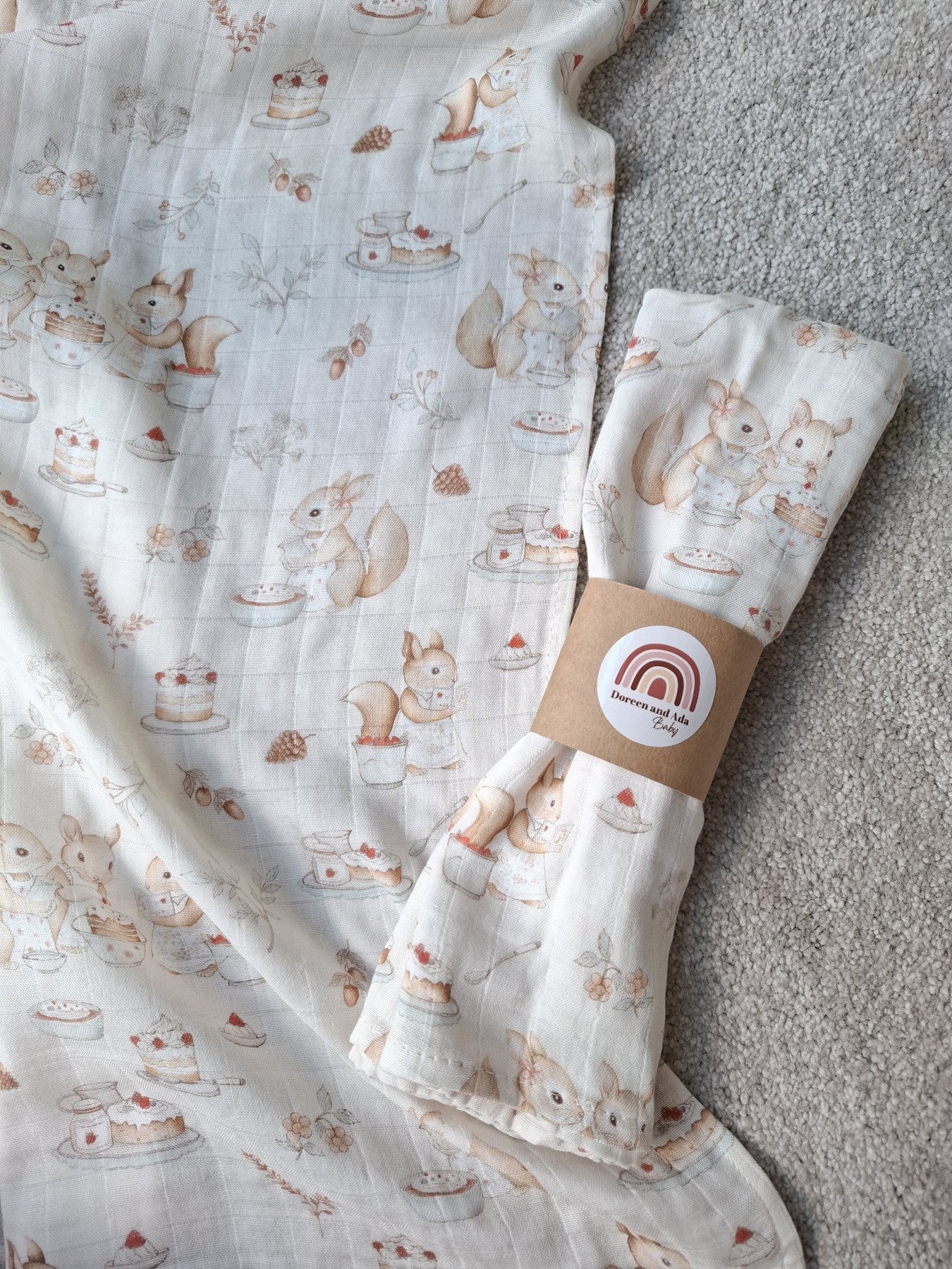 Muslin square laid flat showing complete woodland baking scene with folded muslin on top