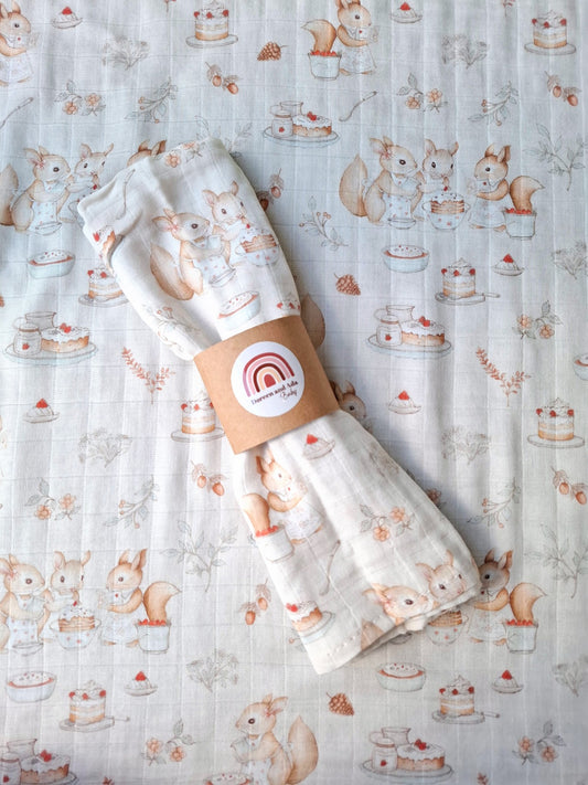 Muslin square with woodland animals baking cakes and sweet treats