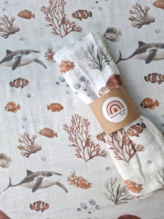 Ocean Friends muslin square with sharks, clownfish, turtles and coral in soft earthy colours