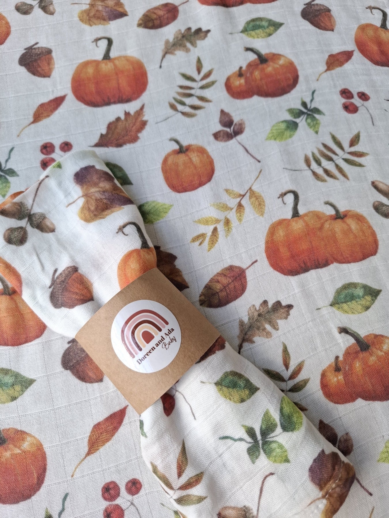 Close-up of Autumn Harvest muslin square featuring pumpkins and leaves design