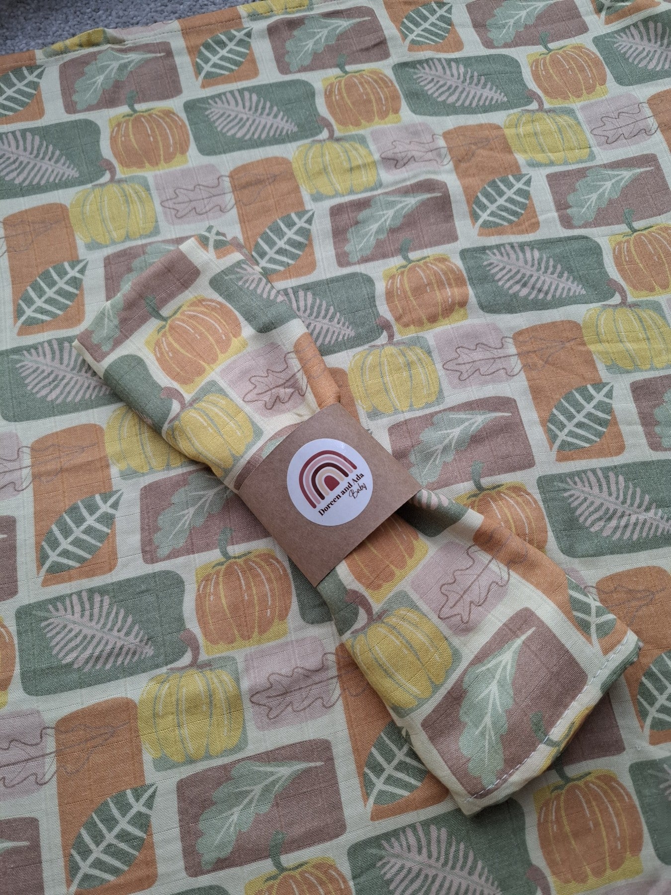 Folded muslin square with autumn pumpkin patch pattern on soft cotton fabric