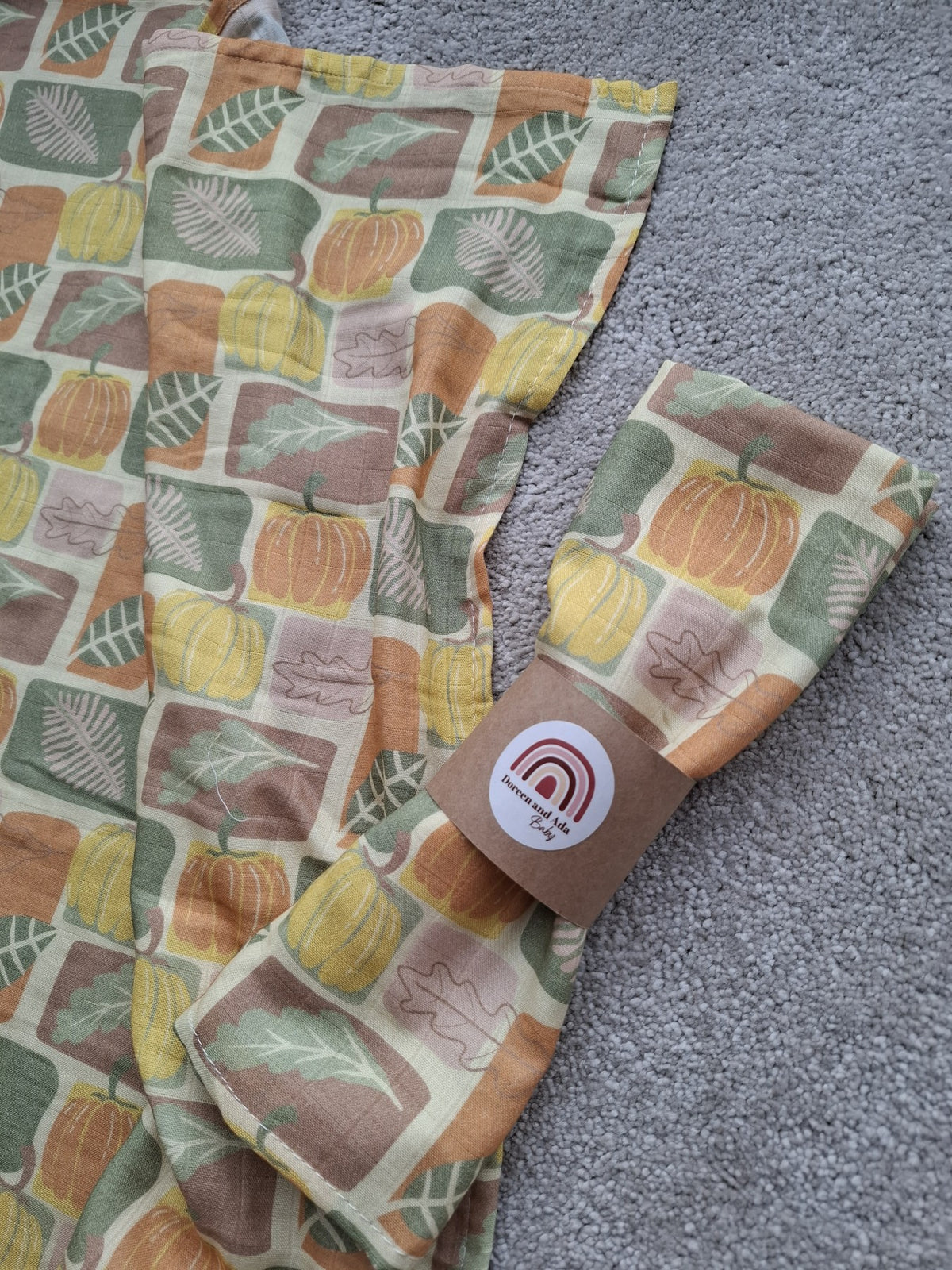 Harvest themed muslin square and matching background showing pumpkin and leaf design