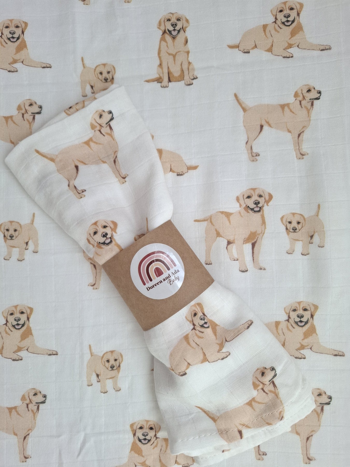 Flat lay of golden labrador puppies muslin square and rolled muslin cloth with natural light