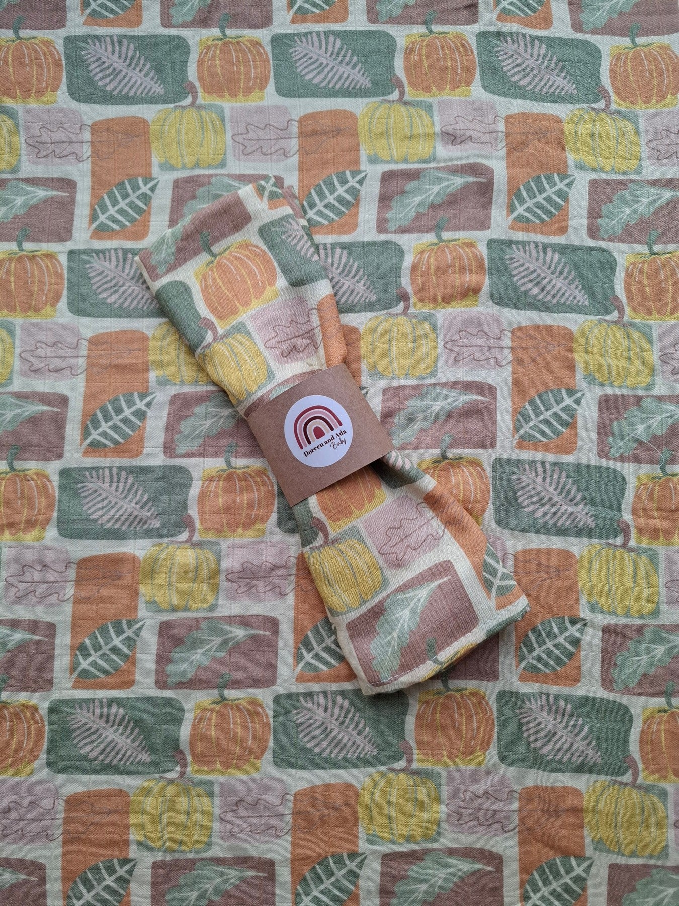 Close-up of the autumn pumpkin and leaf muslin square with soft cotton texture