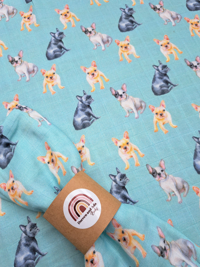 A green muslin square with a pattern of bulldog dogs in various shades of gray and white.