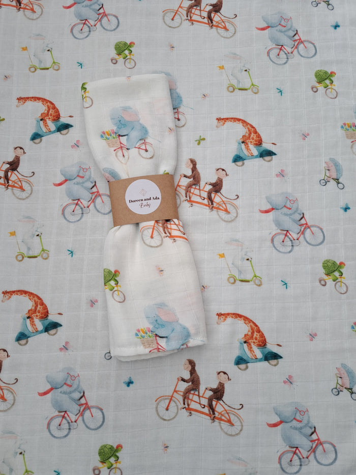 Animals riding bikes print organic cotton muslin square