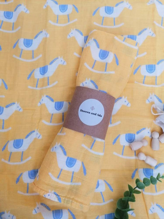 Traditional rocking horse print organic cotton muslin square with nursery toy design