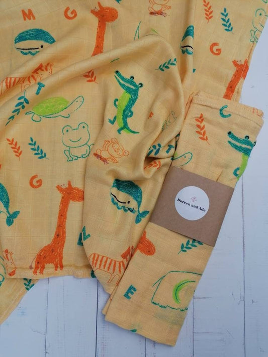Hand-drawn dinosaur print organic cotton muslin square with Jurassic design for babies